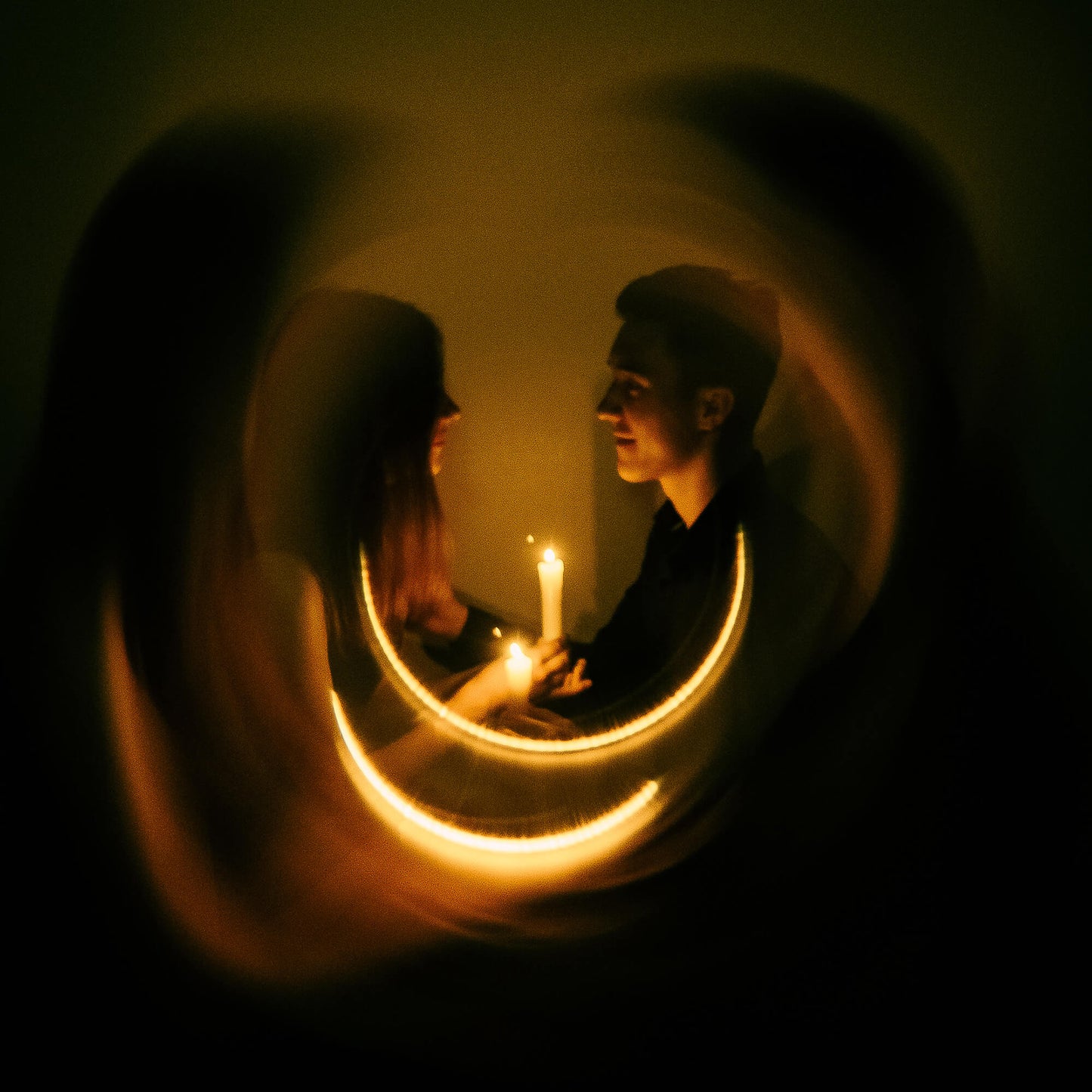 Shot with WalkingWay Halo Prism Effect Fitler - Two people holding hands with candles in a dimly lit room, framed by a circular light effect.